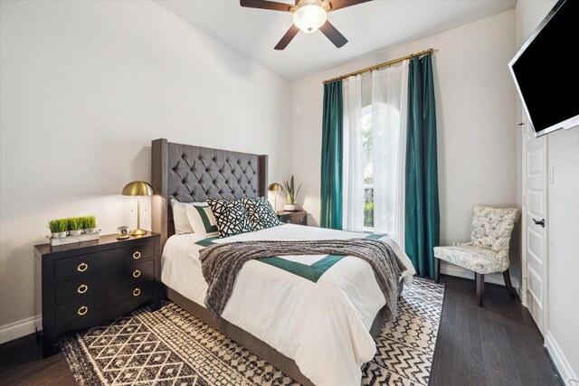 bedroom featuring baseboards, a ceiling fan, vaulted ceiling, and dark wood-style floors