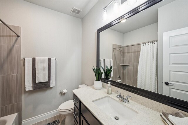 bathroom featuring toilet, visible vents, a shower with shower curtain, and vanity