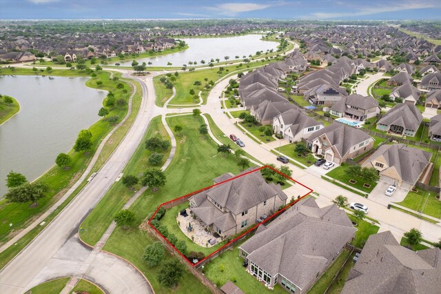 drone / aerial view featuring a water view and a residential view