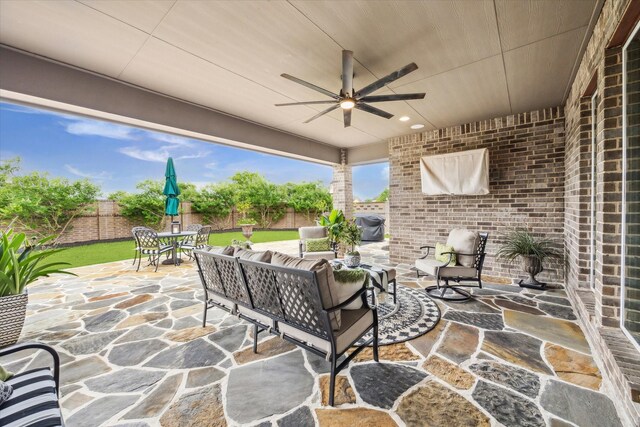 view of patio / terrace with a fenced backyard, outdoor dining area, outdoor lounge area, and ceiling fan