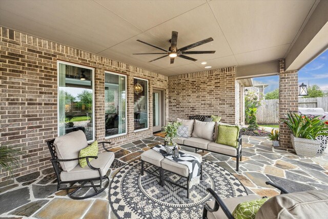 view of patio / terrace with fence, ceiling fan, and outdoor lounge area
