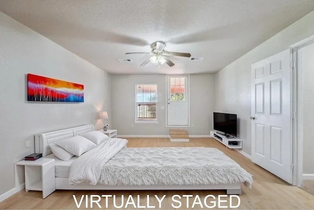 bedroom with baseboards, visible vents, ceiling fan, and light wood finished floors