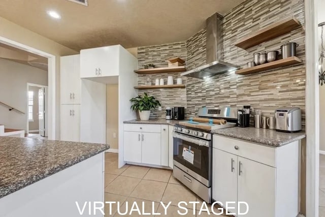 kitchen with white cabinets, stainless steel range with electric cooktop, open shelves, wall chimney exhaust hood, and backsplash