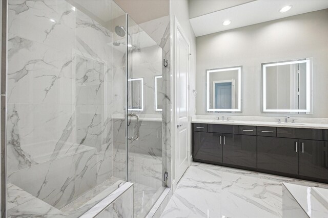 bathroom featuring double vanity, a marble finish shower, a sink, and marble finish floor
