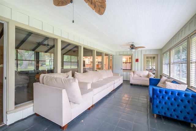 sunroom with ceiling fan and outdoor lounge area