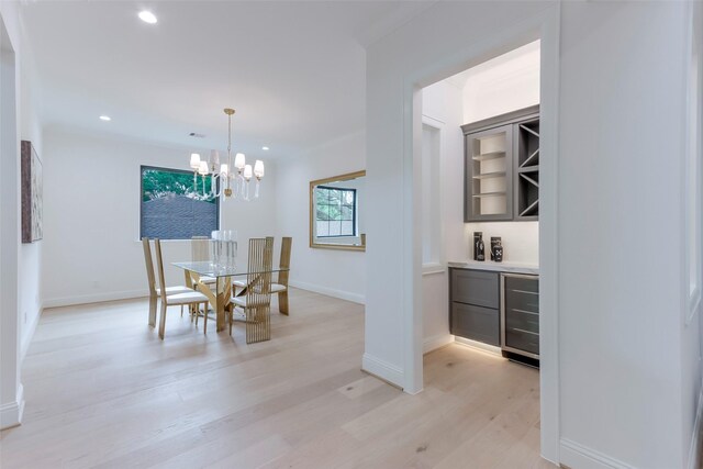 dining room with beverage cooler, a chandelier, recessed lighting, baseboards, and light wood-type flooring