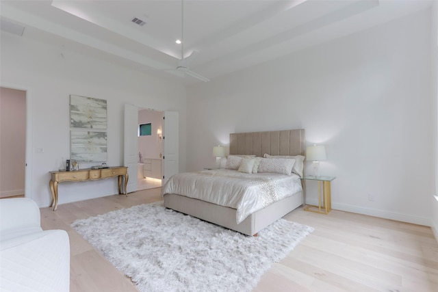 bedroom featuring baseboards, visible vents, and light wood-style flooring