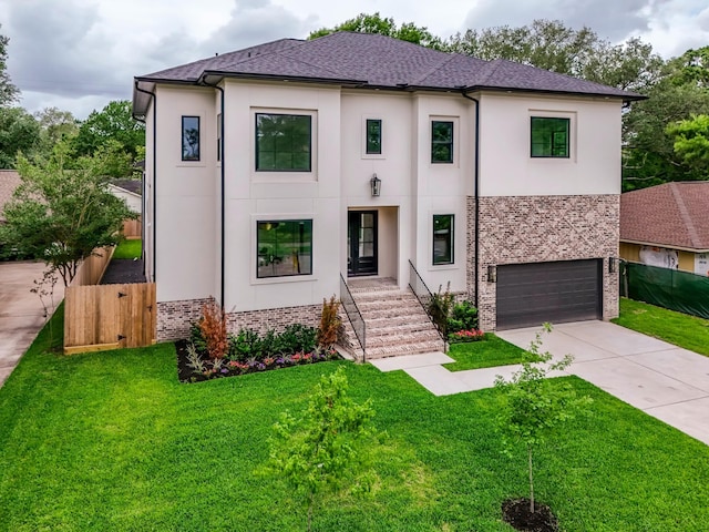 view of front of property featuring a front lawn, stucco siding, fence, and concrete driveway