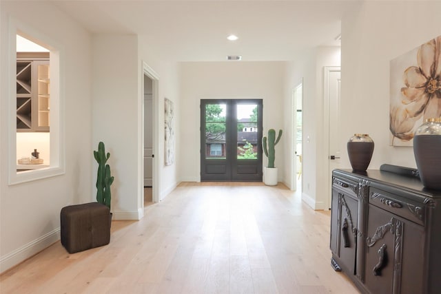 foyer entrance with visible vents, recessed lighting, light wood finished floors, and baseboards
