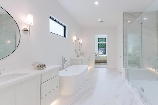 bathroom featuring a freestanding tub, marble finish floor, ensuite bathroom, recessed lighting, and a shower stall
