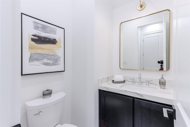 bathroom featuring toilet and vanity