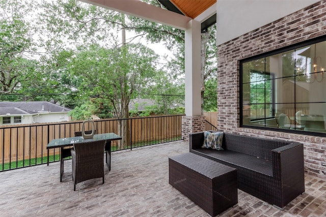 view of patio featuring fence, outdoor dining area, and an outdoor hangout area