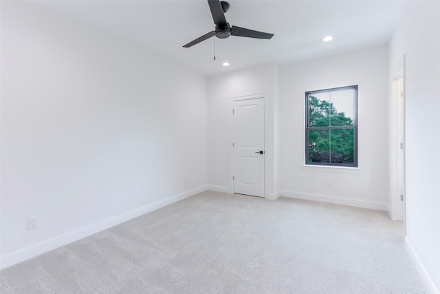 spare room with baseboards, a ceiling fan, recessed lighting, and light colored carpet