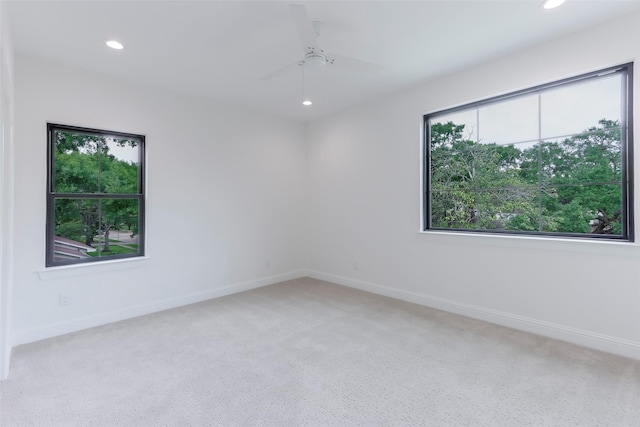 empty room featuring baseboards, light carpet, a ceiling fan, and recessed lighting