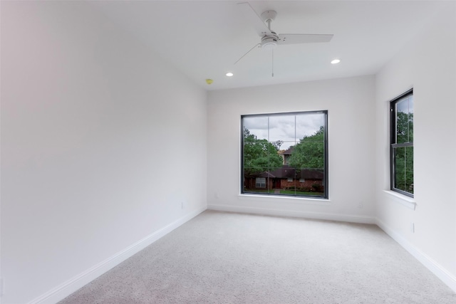 empty room with recessed lighting, baseboards, light colored carpet, and a ceiling fan