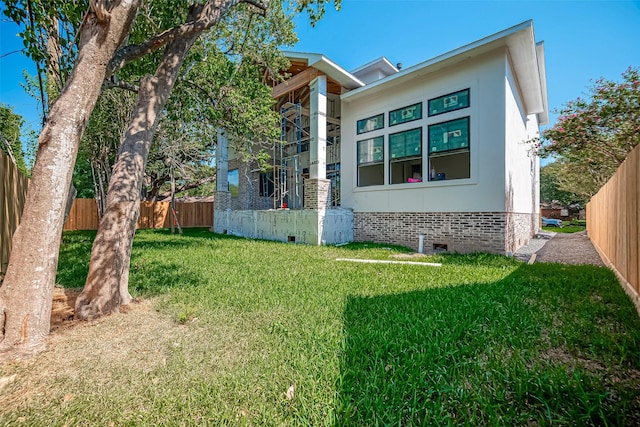exterior space featuring fence, a yard, and crawl space