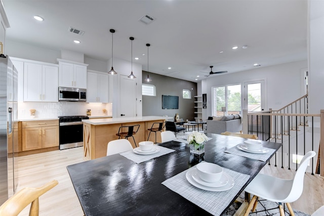 dining room featuring visible vents, recessed lighting, light wood-style flooring, and ceiling fan