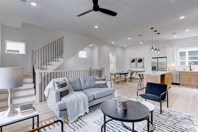 living area featuring recessed lighting, ceiling fan, visible vents, and light wood finished floors