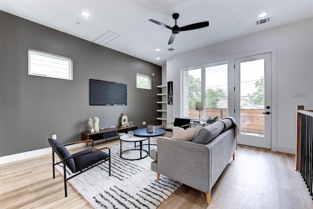 living room with recessed lighting, ceiling fan, and light wood-style flooring