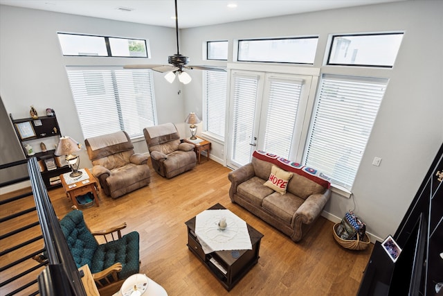 living area with recessed lighting, ceiling fan, and wood finished floors