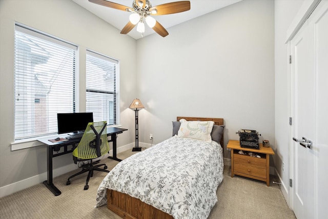 bedroom featuring baseboards, a ceiling fan, and light carpet