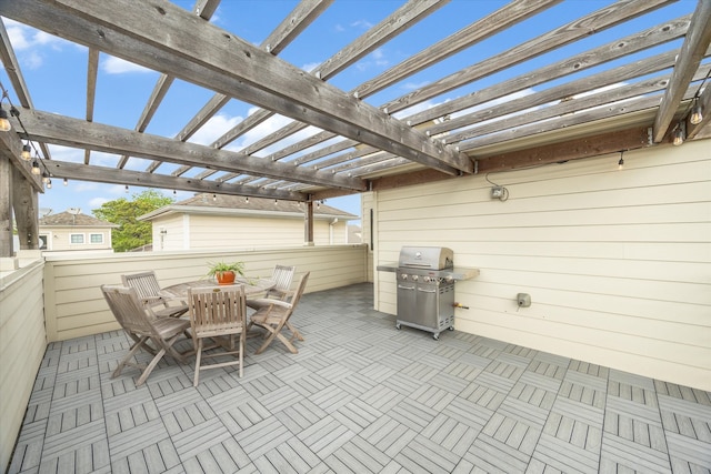 view of patio with outdoor dining area, a pergola, and grilling area