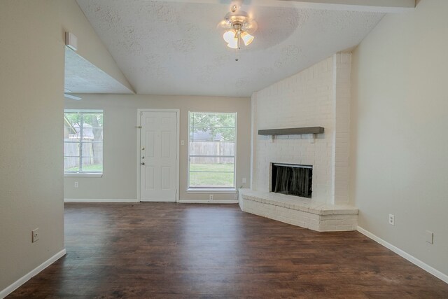 unfurnished living room with a ceiling fan, vaulted ceiling, and dark wood-style floors