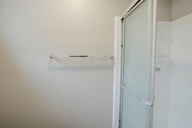 bathroom with a shower stall