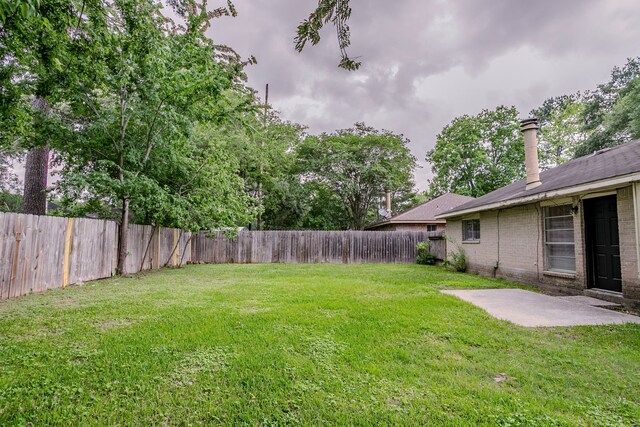 view of yard with a fenced backyard and a patio area