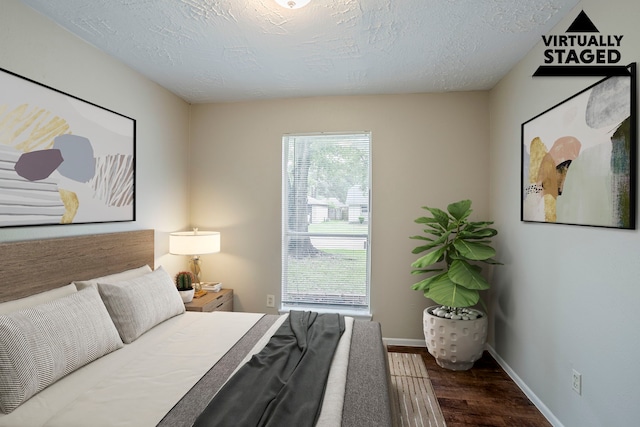 4523 Towergate Dr, Spring, TX 77373 - bedroom featuring wood finished floors, baseboards, and a textured ceiling