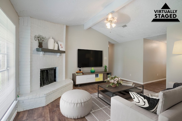 4523 Towergate Dr, Spring, TX 77373 - living room featuring wood finished floors, ceiling fan, a fireplace, baseboards, and a textured ceiling