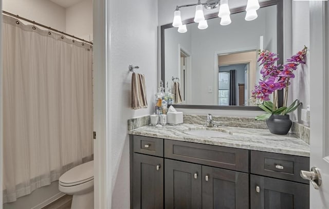full bath with vanity, shower / bath combo, toilet, and wood finished floors