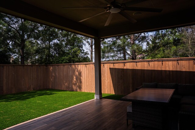 view of patio featuring a fenced backyard, ceiling fan, and a deck