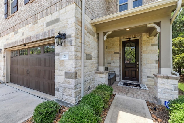 26 Heirloom Garden Pl, Magnolia, TX 77354 - view of exterior entry featuring stone siding, a garage, and driveway