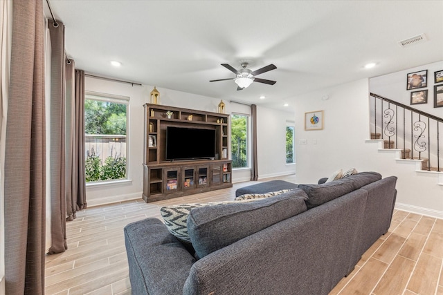 26 Heirloom Garden Pl, Magnolia, TX 77354 - living area featuring wood tiled floors, a ceiling fan, stairway, baseboards, and recessed lighting