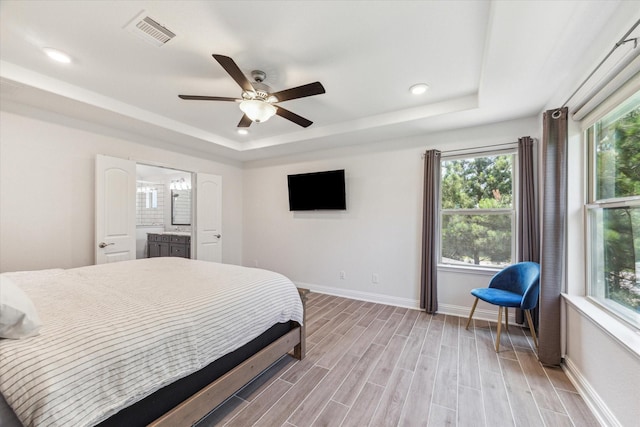 26 Heirloom Garden Pl, Magnolia, TX 77354 - bedroom featuring a tray ceiling, baseboards, light wood finished floors, recessed lighting, and a ceiling fan