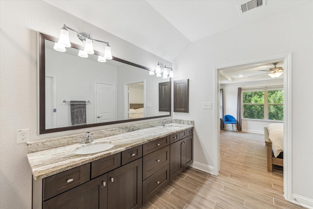 26 Heirloom Garden Pl, Magnolia, TX 77354 - full bathroom with ensuite bathroom, double vanity, wood finished floors, baseboards, and lofted ceiling