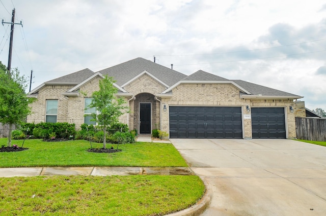 12630 Beddington Ct, Tomball, TX 77375 - french provincial home featuring driveway, a shingled roof, a front yard, and a garage