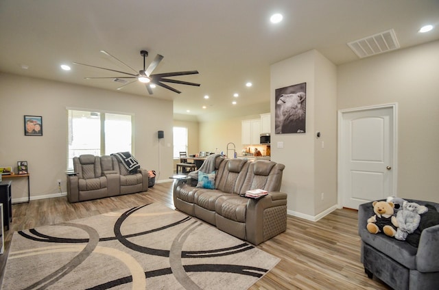 12630 Beddington Ct, Tomball, TX 77375 - living area with ceiling fan, visible vents, baseboards, recessed lighting, and light wood-style flooring
