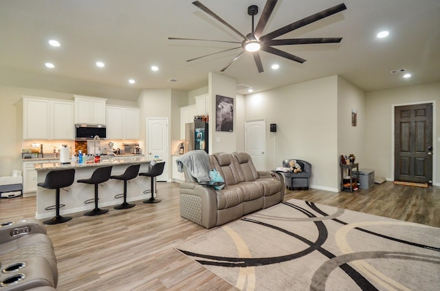 12630 Beddington Ct, Tomball, TX 77375 - living area with recessed lighting, baseboards, ceiling fan, and light wood-type flooring