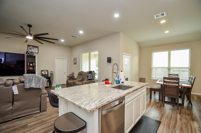 12630 Beddington Ct, Tomball, TX 77375 - kitchen featuring a sink, open floor plan, light wood-type flooring, stainless steel dishwasher, and visible vents