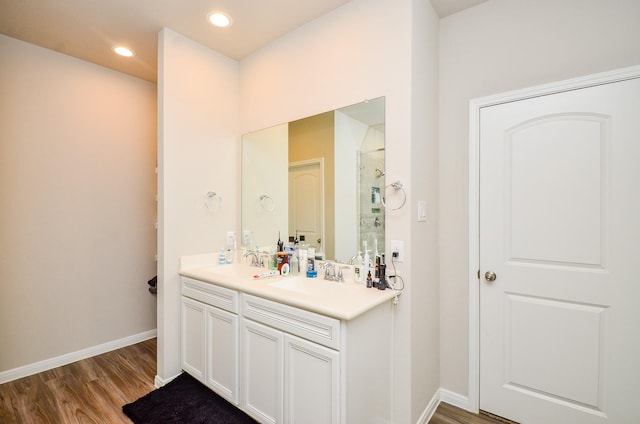 12630 Beddington Ct, Tomball, TX 77375 - full bathroom featuring a sink, double vanity, walk in shower, and wood finished floors