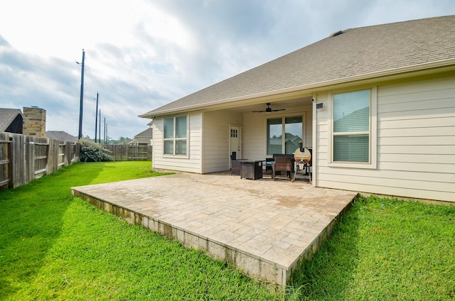 12630 Beddington Ct, Tomball, TX 77375 - back of property featuring a lawn, ceiling fan, a fenced backyard, and a patio area