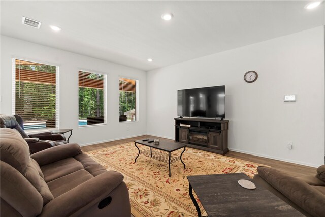 living room featuring visible vents, recessed lighting, light wood-style floors, and a healthy amount of sunlight