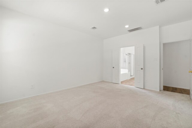 unfurnished room with light colored carpet, recessed lighting, and visible vents