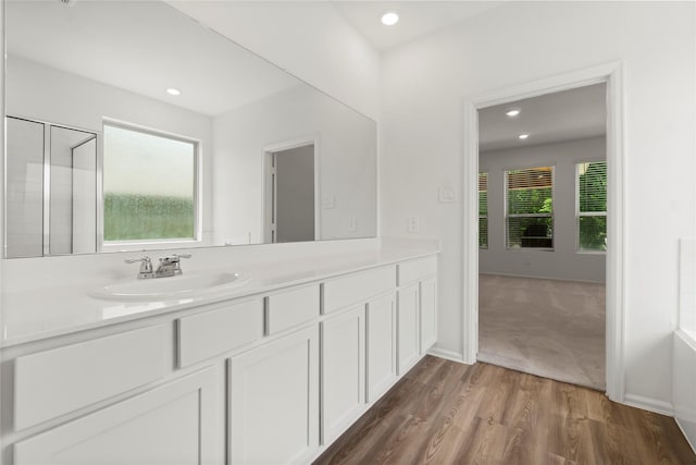 full bathroom featuring recessed lighting, wood finished floors, and vanity