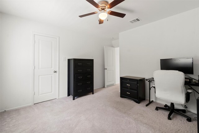 home office featuring baseboards, ceiling fan, light colored carpet, and visible vents