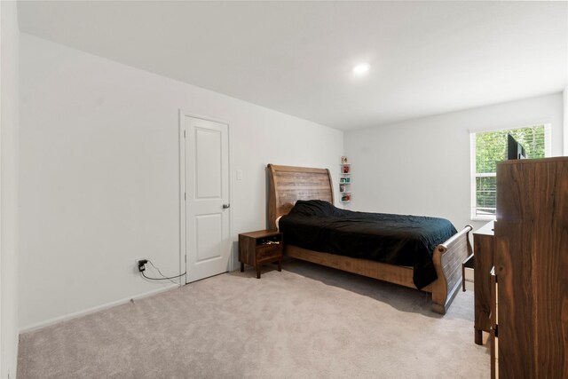 bedroom featuring recessed lighting, baseboards, and light colored carpet