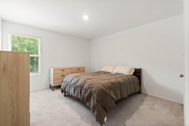 bedroom featuring recessed lighting, baseboards, and light carpet
