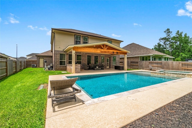 view of pool with an outdoor living space, a fenced backyard, a yard, and a patio